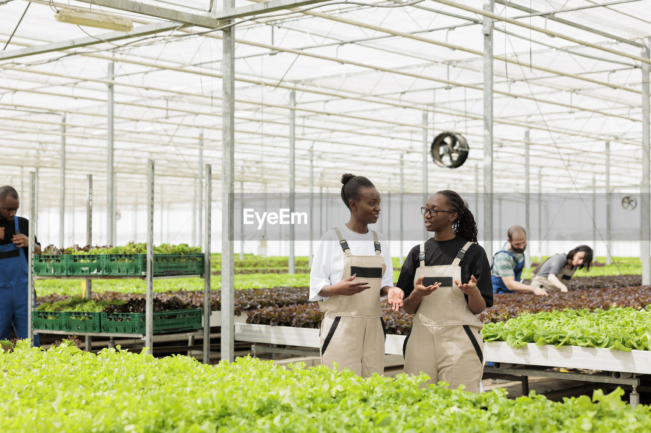 rear view of young man standing by plants