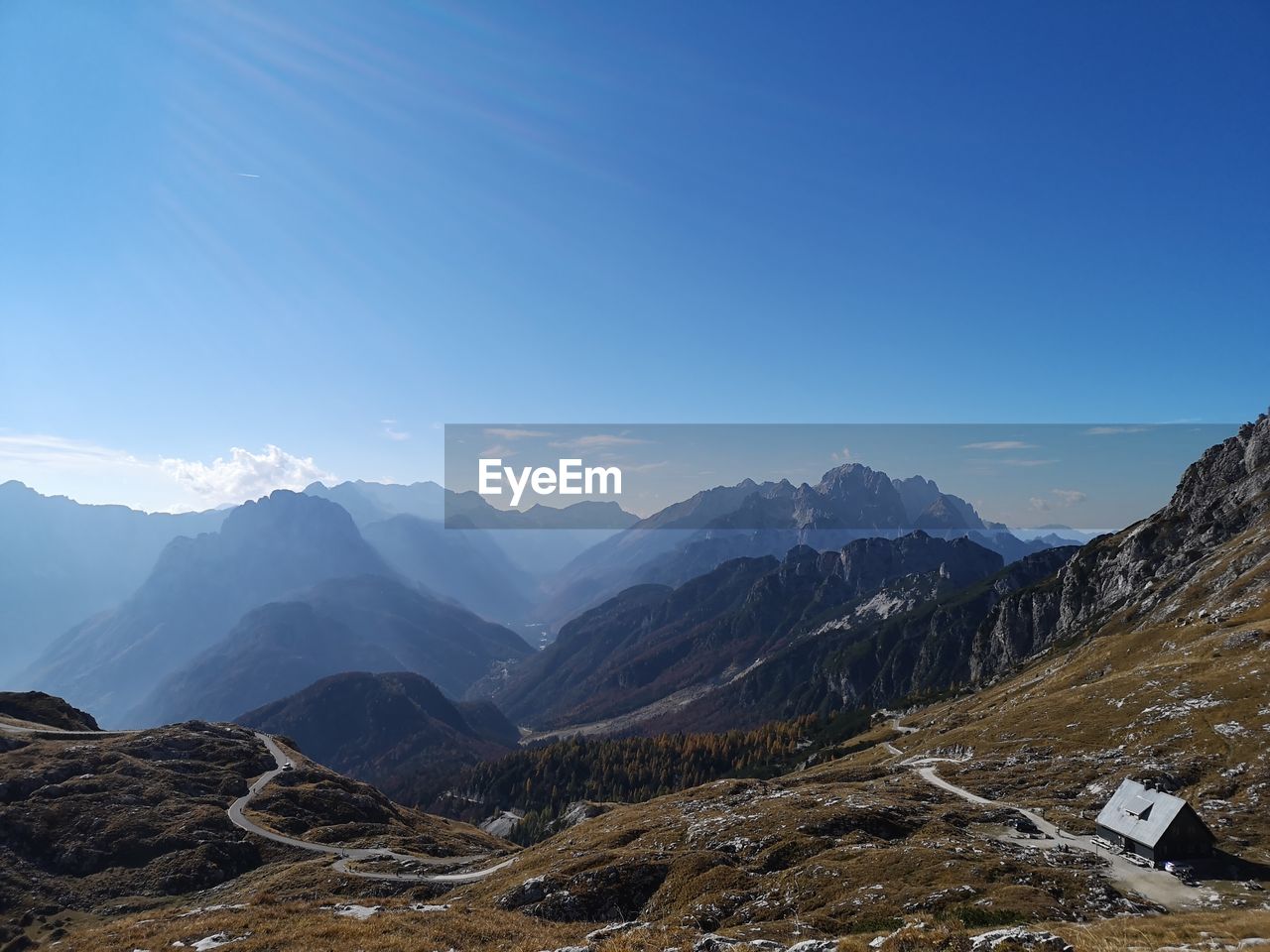 Scenic view of mountains against blue sky