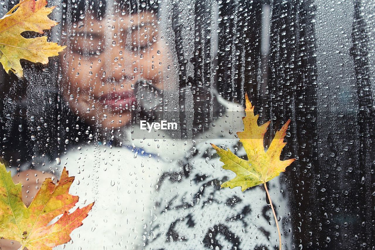 Woman seen wet window during rainy season