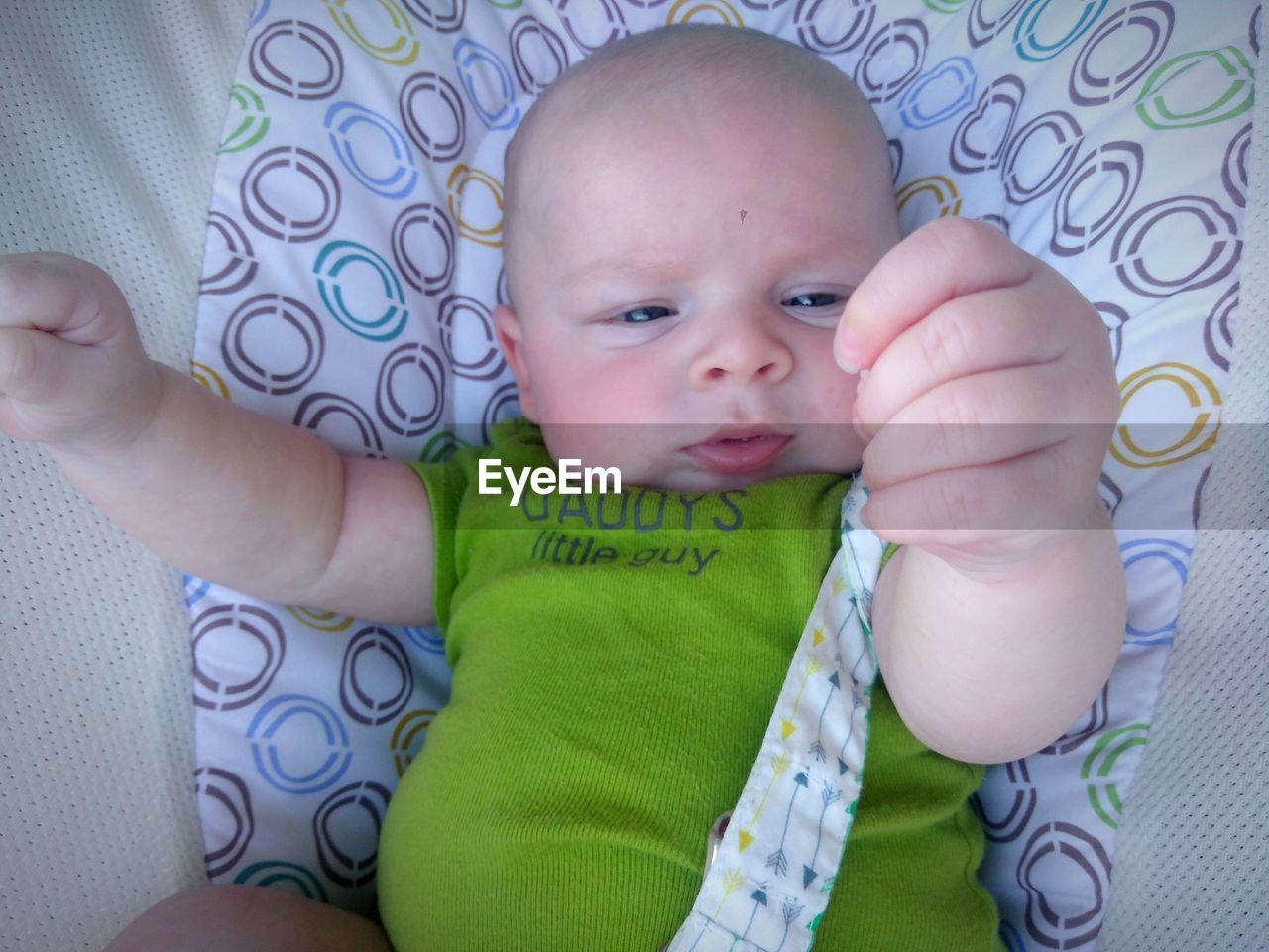 Close-up of cute baby boy in crib