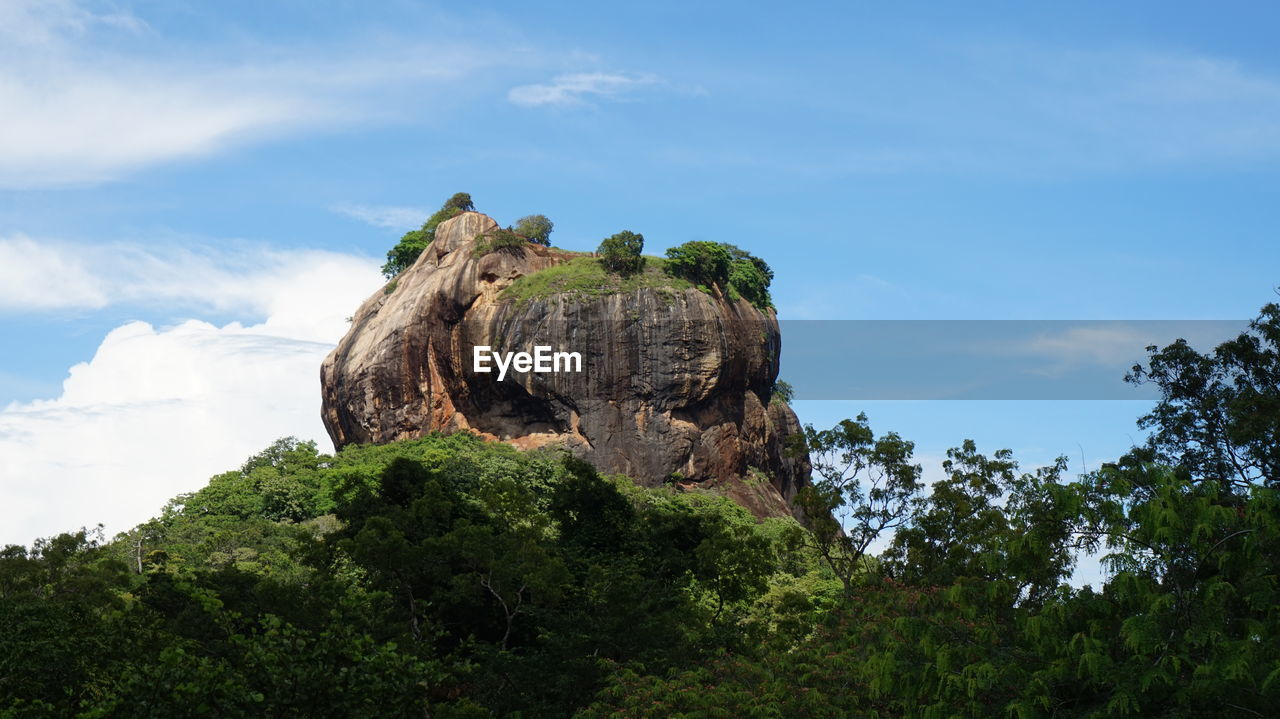 Low angle view of rock formation against sky