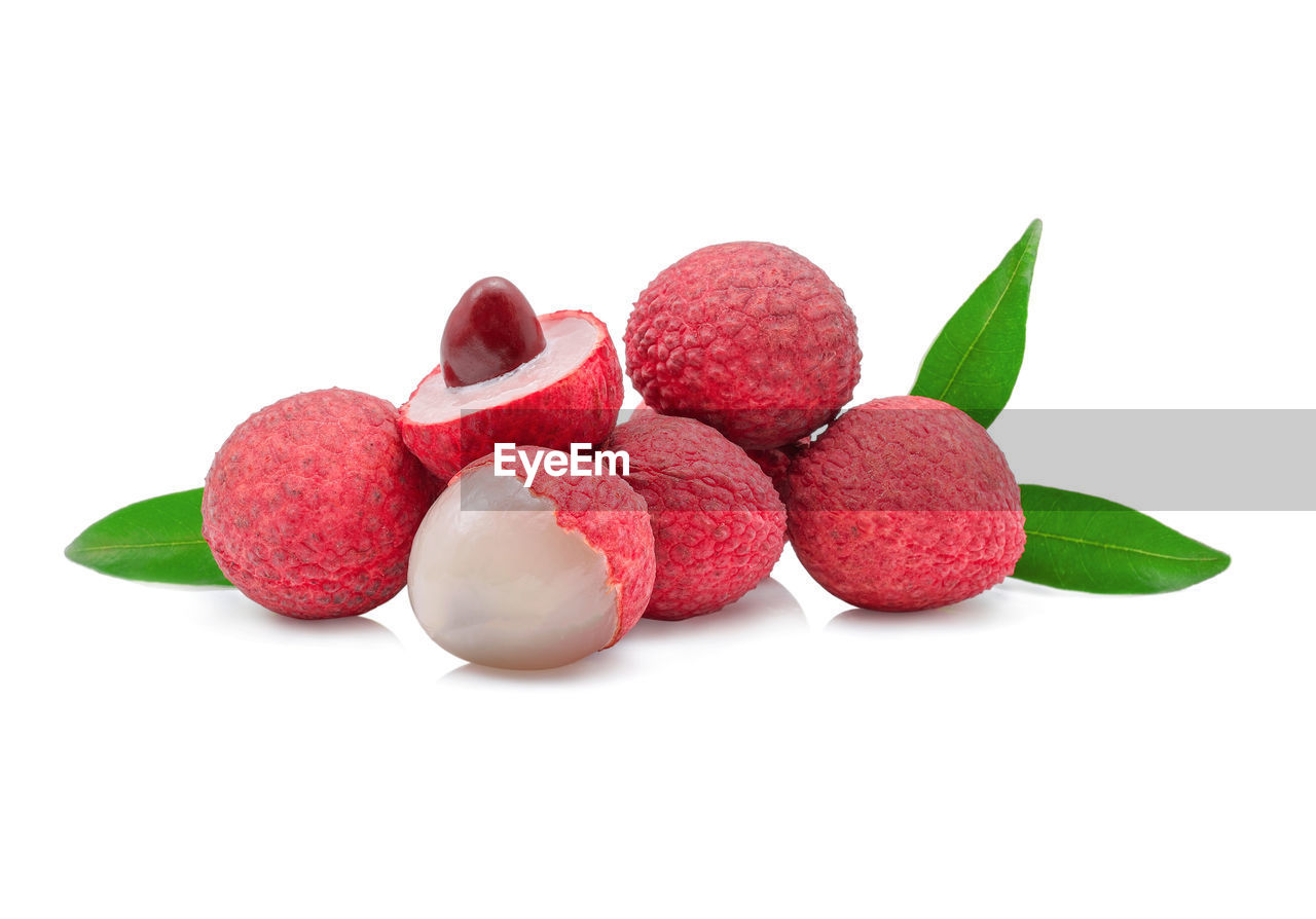 Close-up of lychees over white background