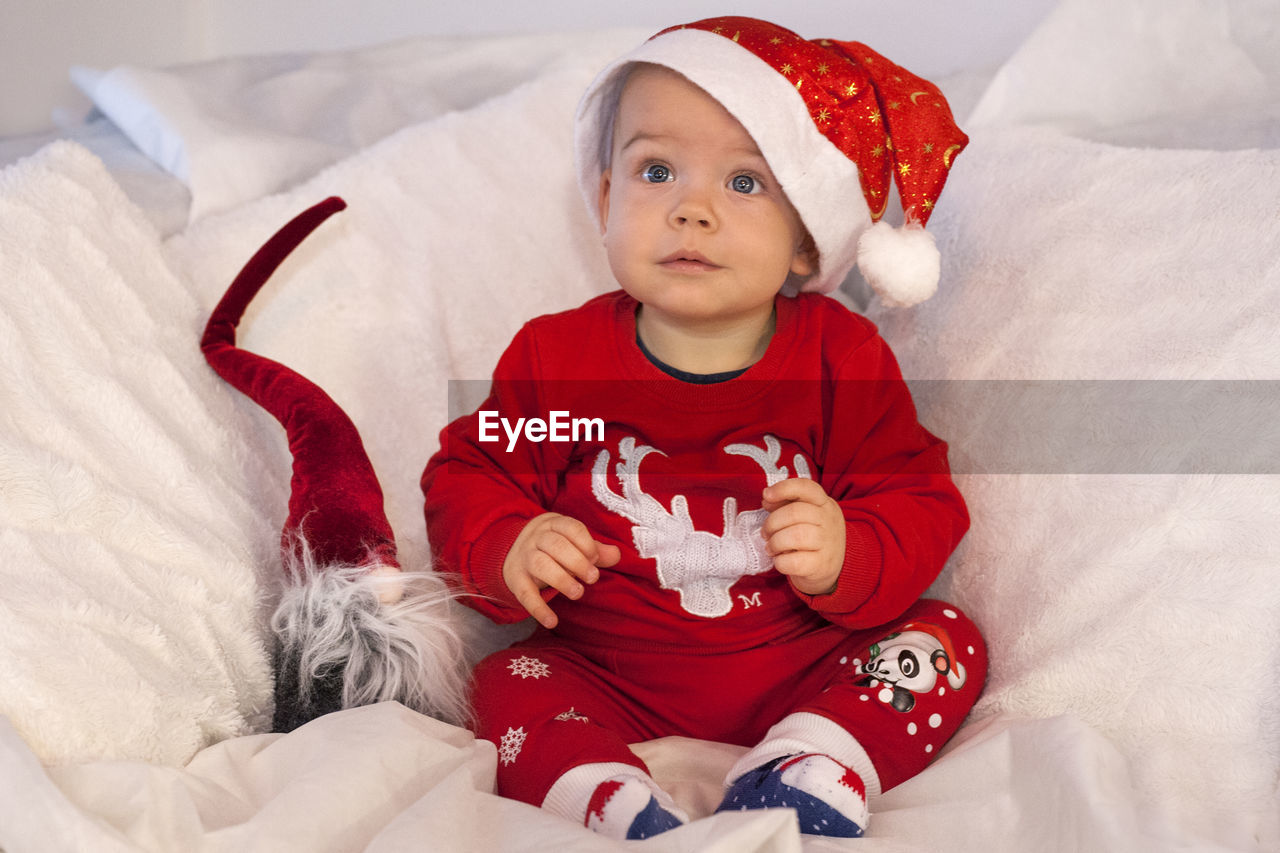 Cute baby boy dressed in santa dress