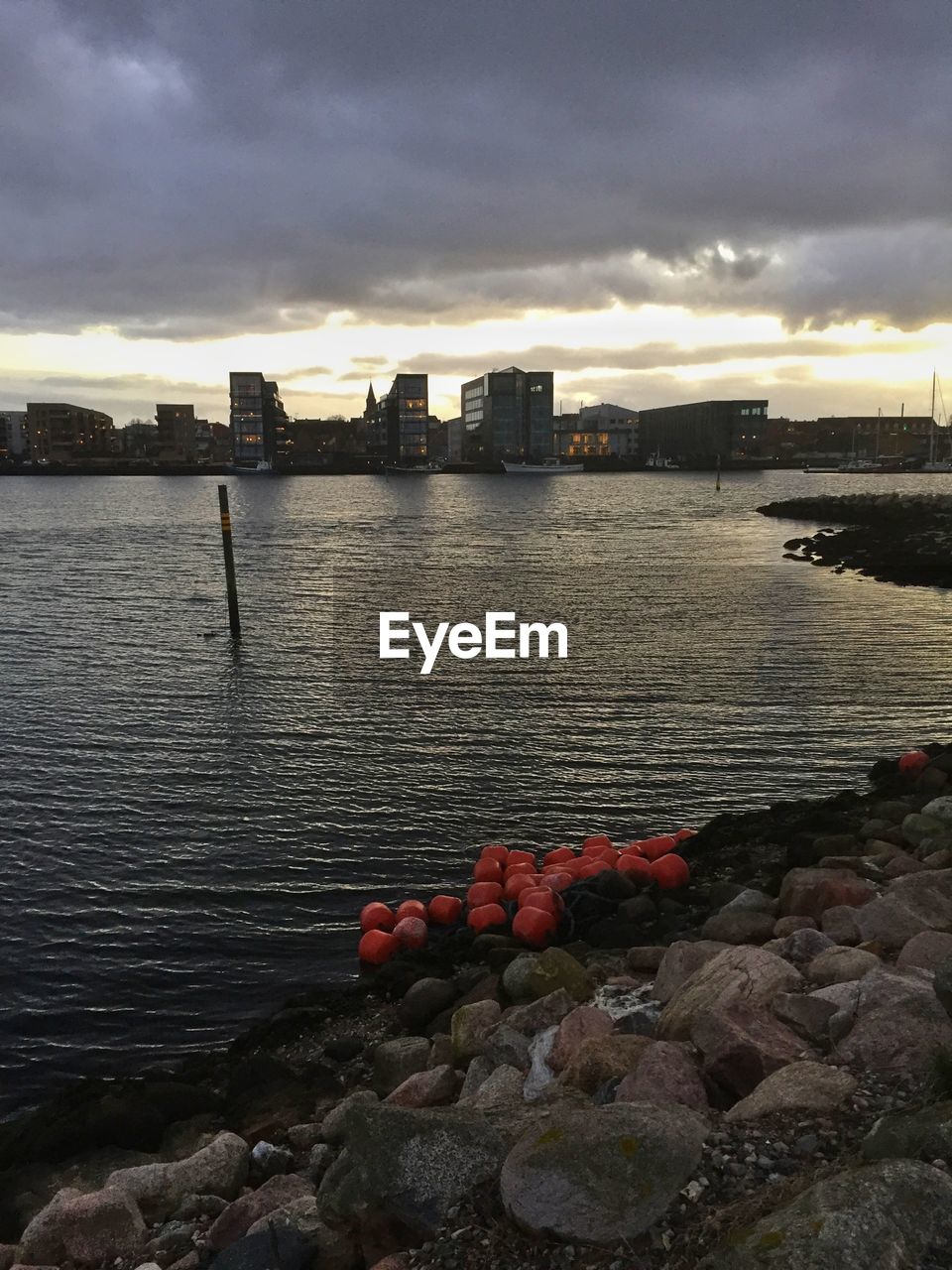 View of sea against cloudy sky at sunset