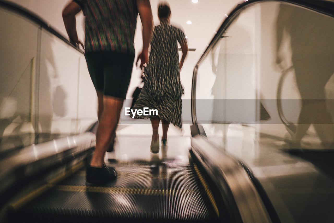 People moving on escalator