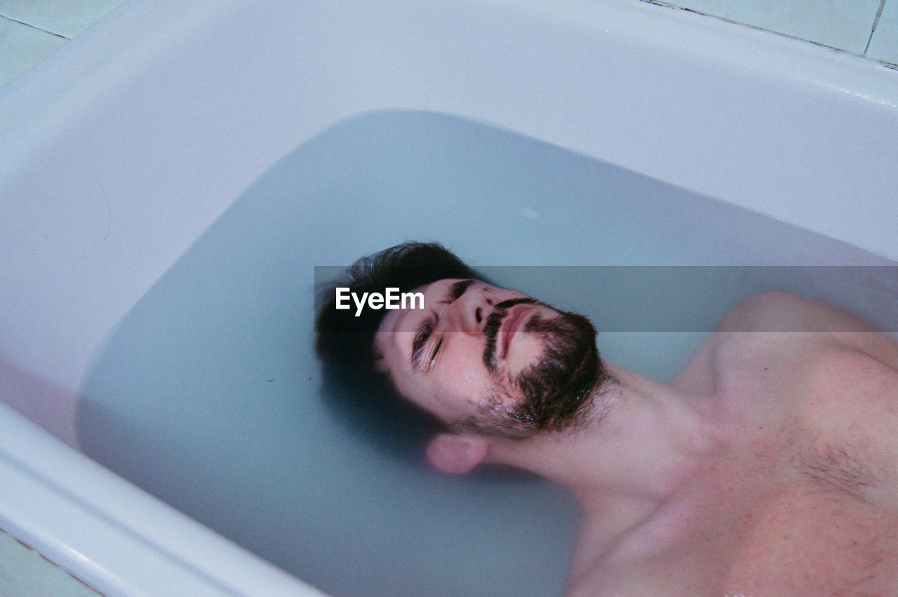 View of handsome man in bathtub 