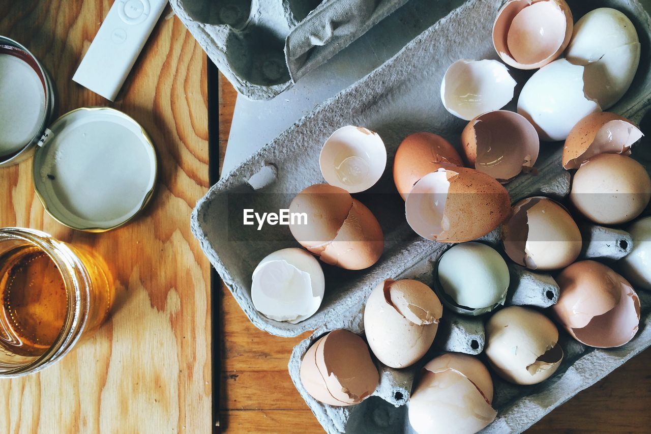 Directly above view of eggshells in carton on table