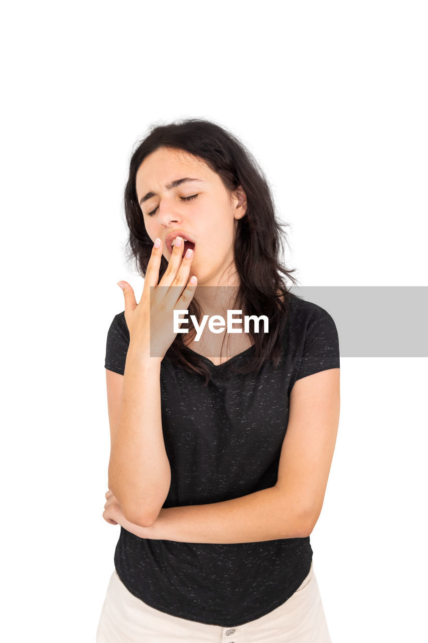 one person, women, studio shot, white background, adult, indoors, young adult, cut out, emotion, finger, portrait, female, casual clothing, hand, relaxation, waist up, negative emotion, front view, clothing, hairstyle, arm, long hair, frustration, eyes closed, copy space, person, lifestyles, photo shoot, communication, standing, mouth open, happiness, facial expression, three quarter length, looking, black, brown hair, positive emotion, limb