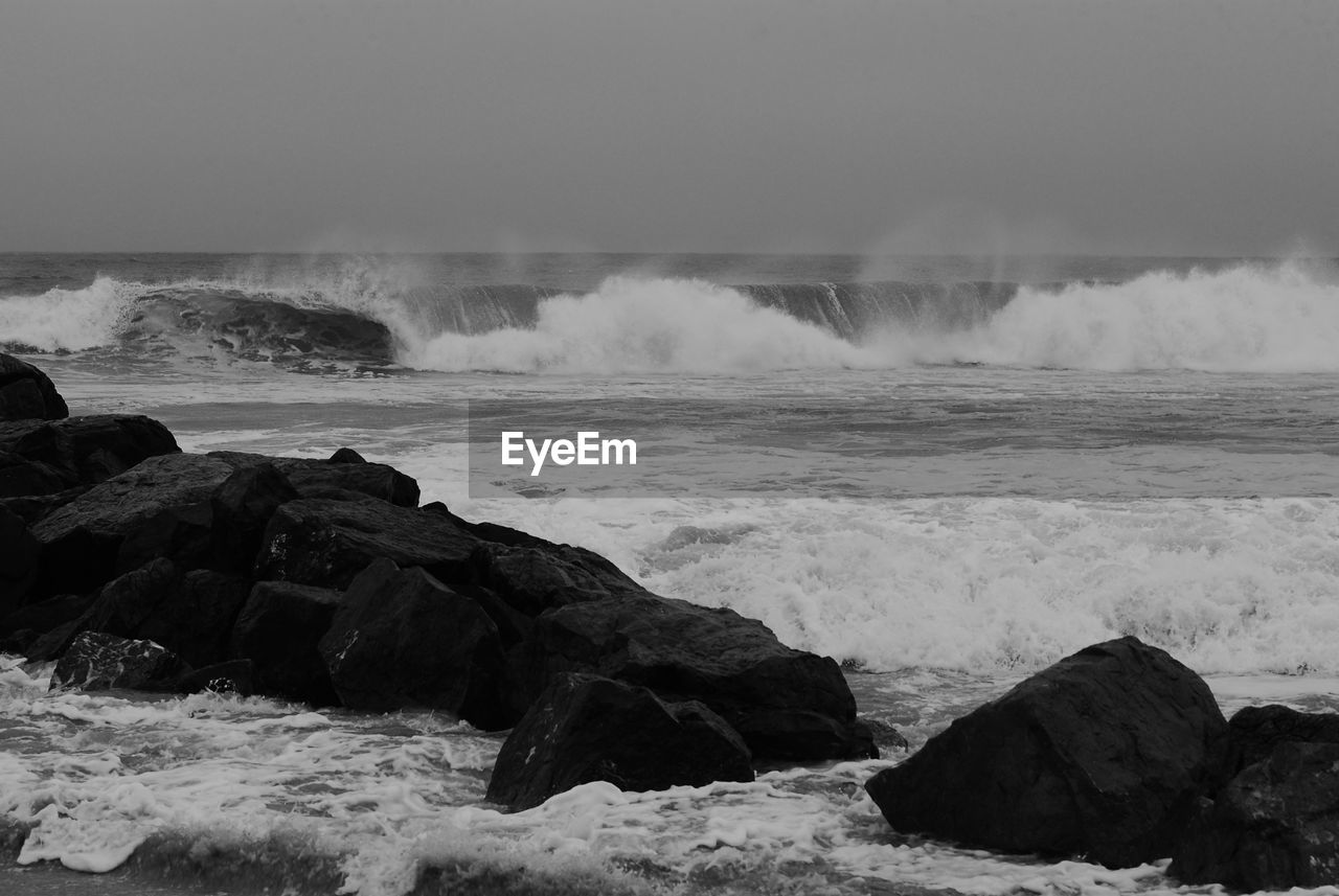 Waves splashing on rocks at beach