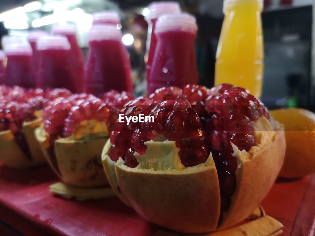 CLOSE-UP OF RASPBERRIES IN GLASS ON TABLE