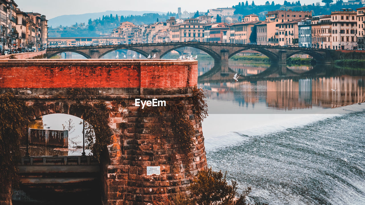 Arch bridge over river in city