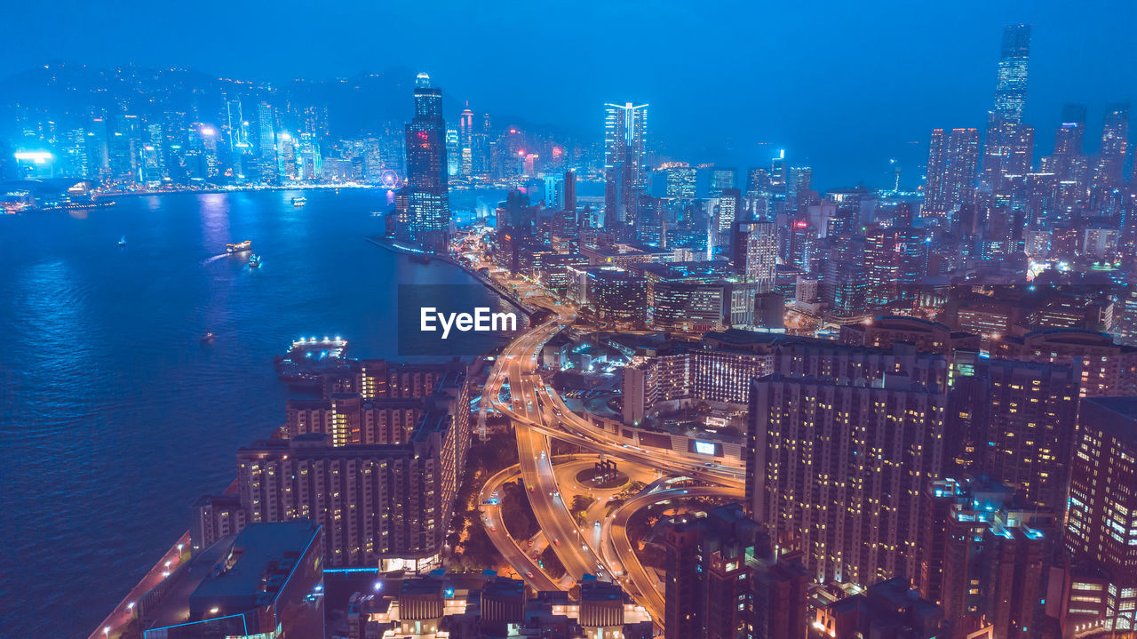 High angle view of illuminated buildings in city at night