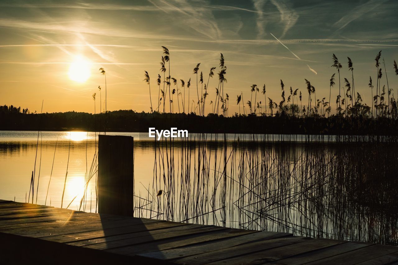 Scenic view of lake against sky during sunset