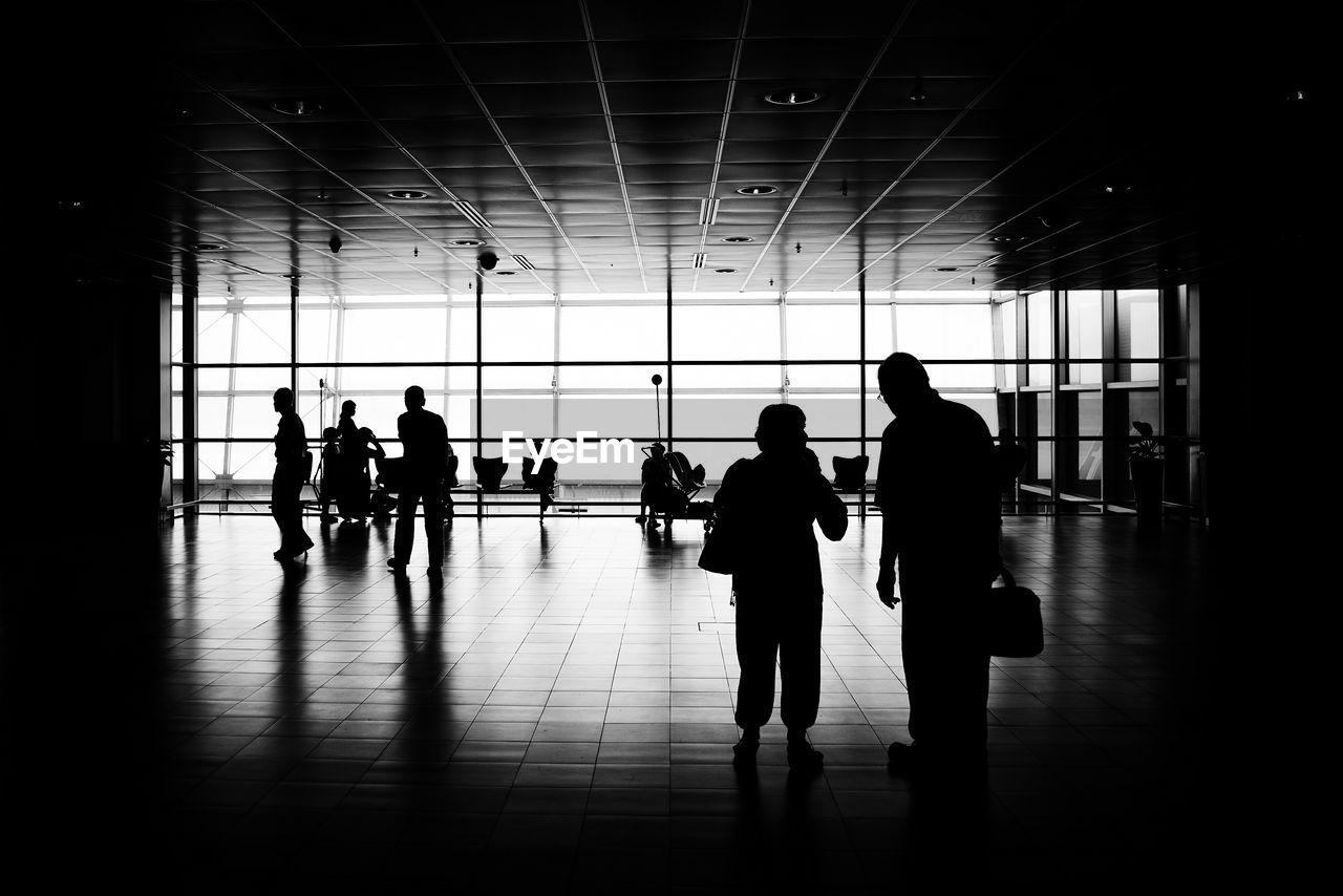 Silhouette people standing in airport