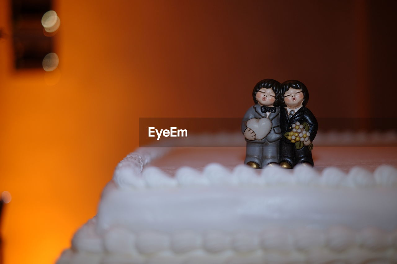 FIGURINE OF CAKE ON TABLE