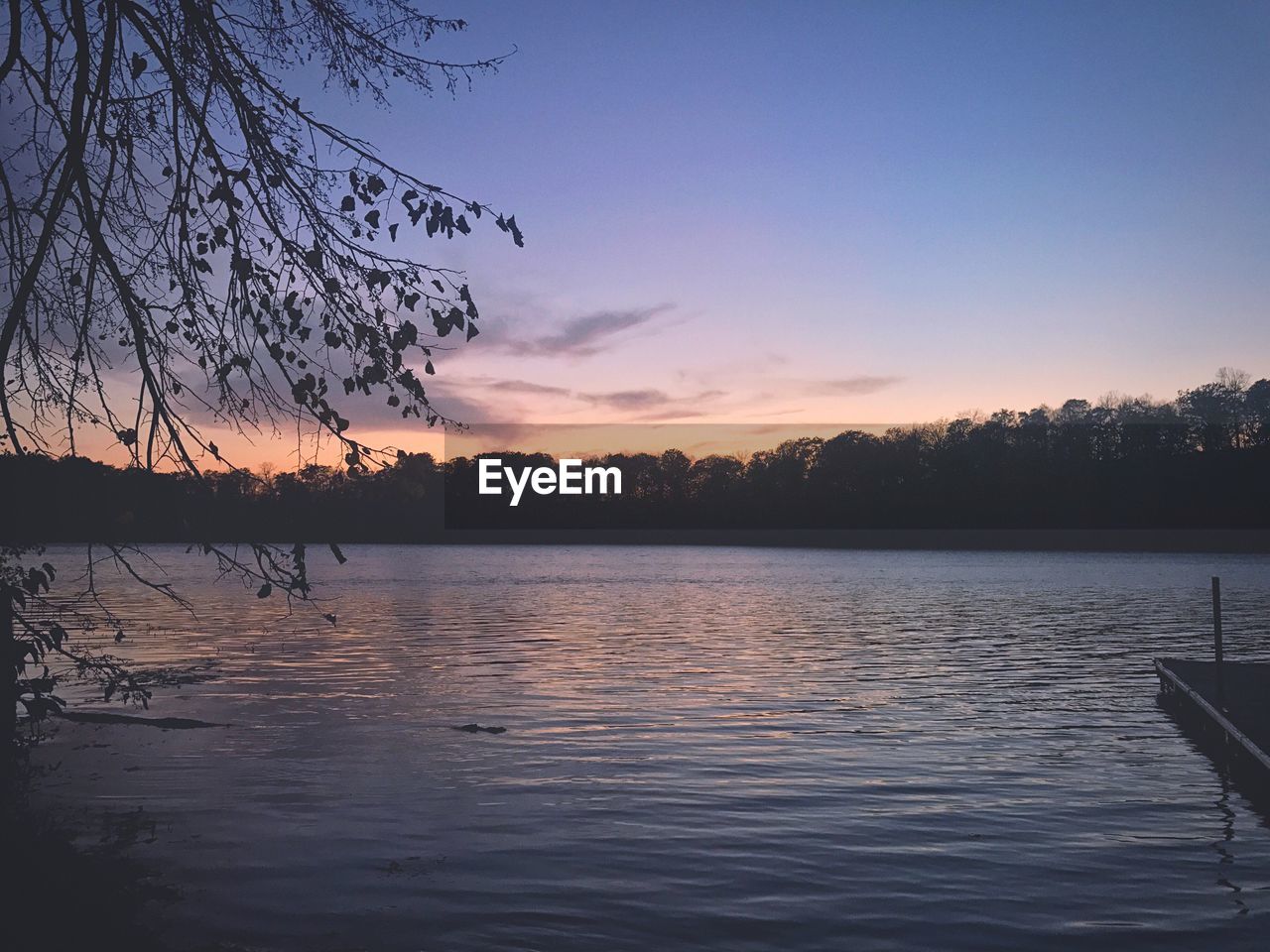 SCENIC VIEW OF LAKE BY SILHOUETTE TREES AGAINST SKY