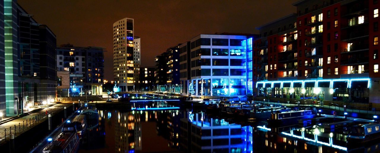 VIEW OF ILLUMINATED CITY AT NIGHT