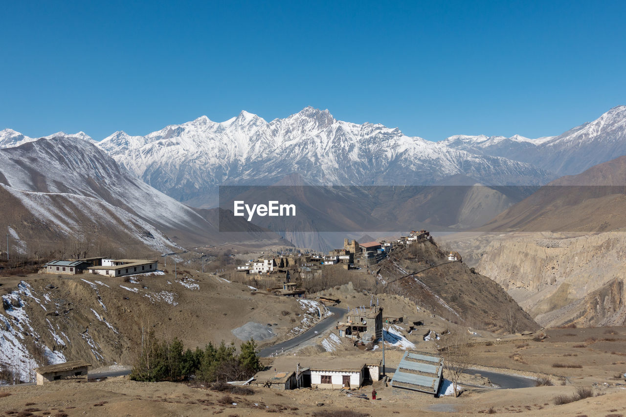 Scenic view of mountains against blue sky