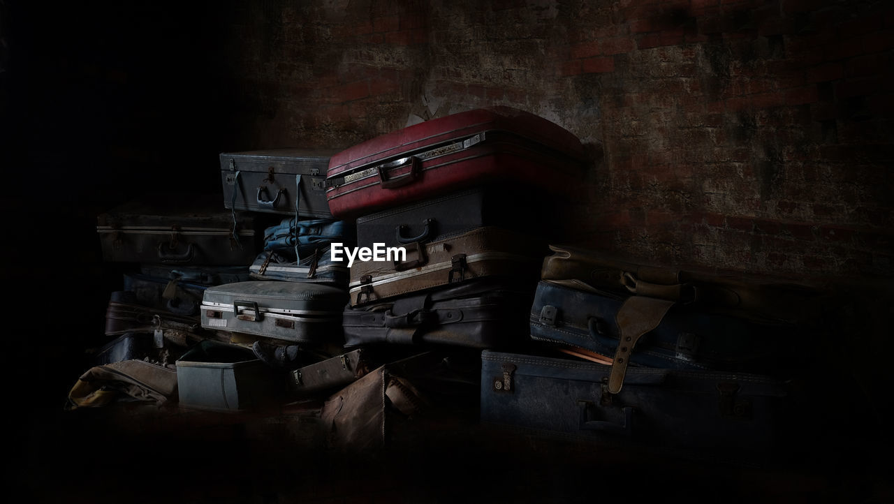 Old suitcases stacked against wall
