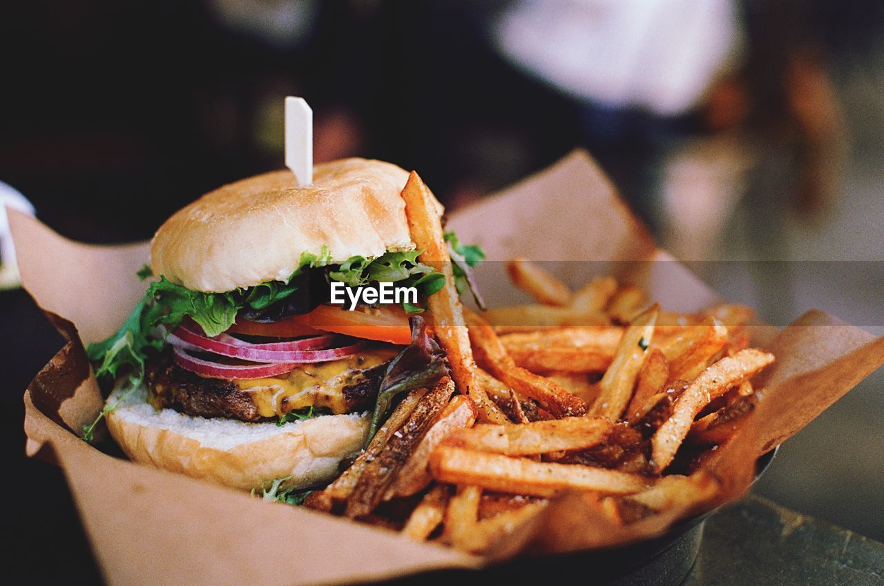 Close-up of burger with french fries on table