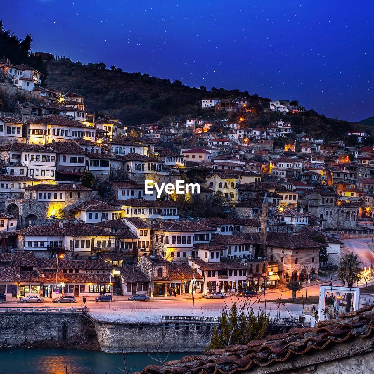 Illuminated cityscape against clear sky at night