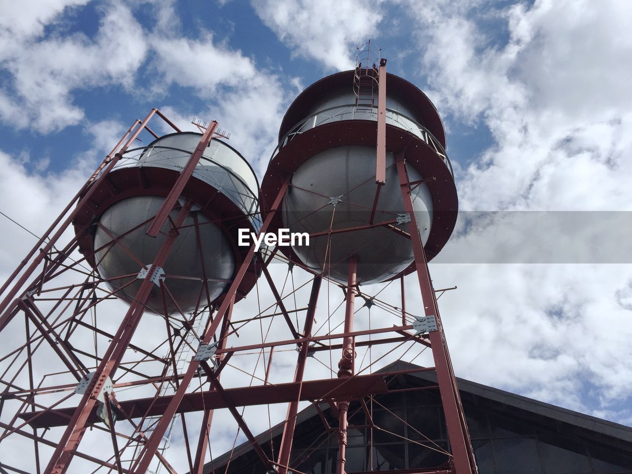 Low angle view of water towers against sky