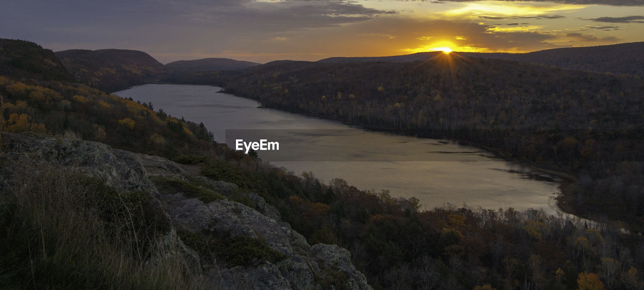 Scenic view of lake against sky during sunset