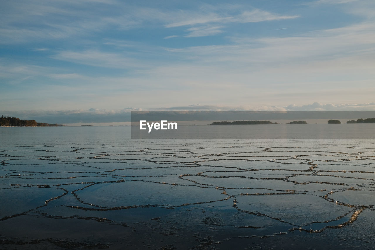 Scenic view of the frozen sea against sky during sunset