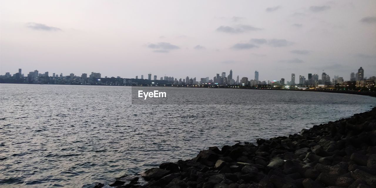 Scenic view of sea and buildings against sky