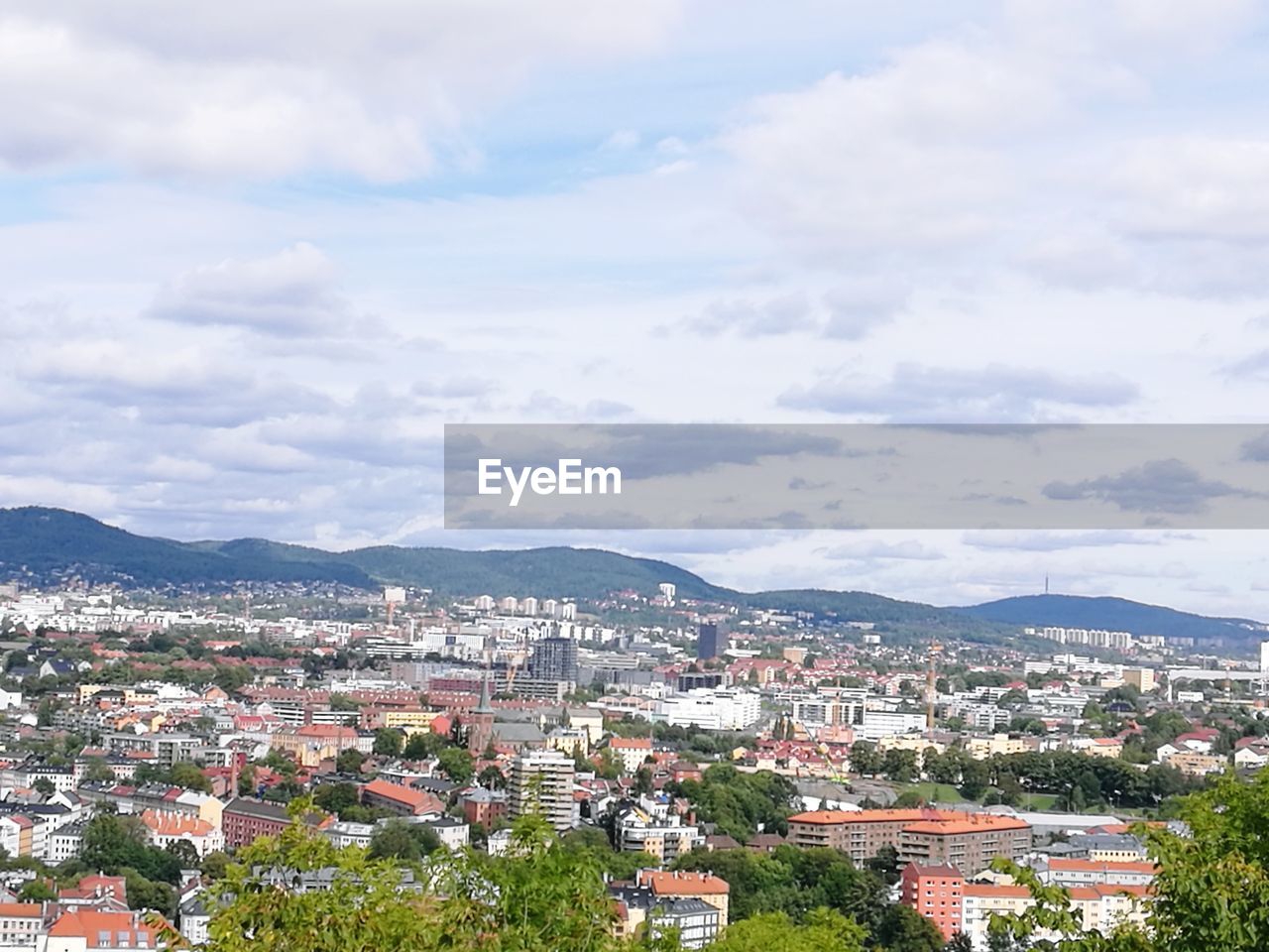 High angle view of houses in town against sky