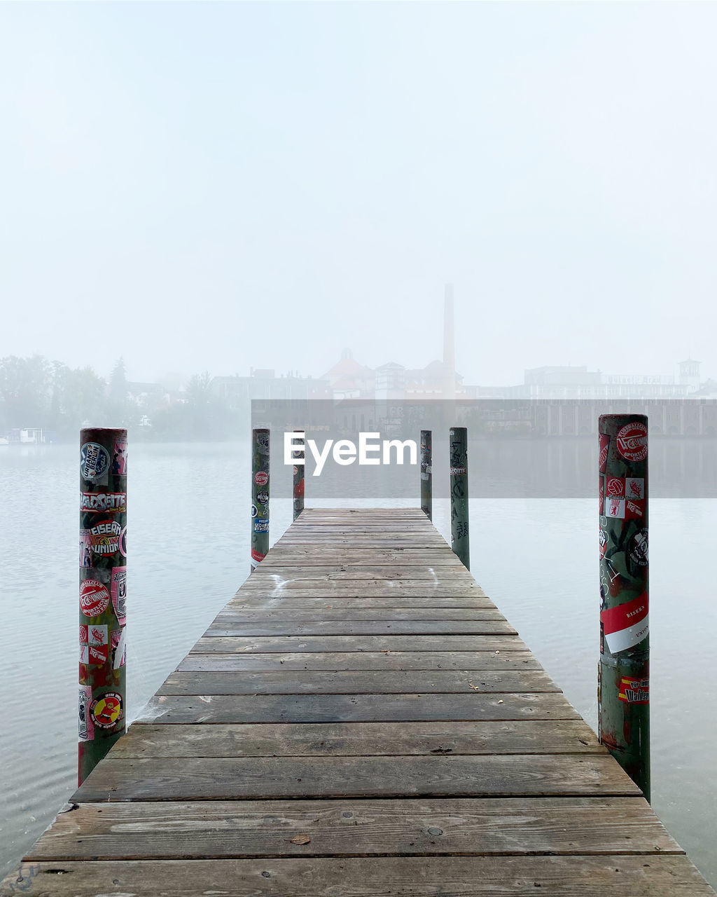 VIEW OF WOODEN PIER OVER LAKE AGAINST SKY