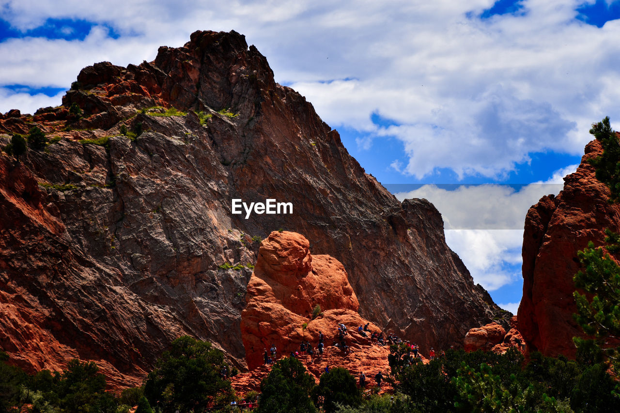 View of rock formation against cloudy sky