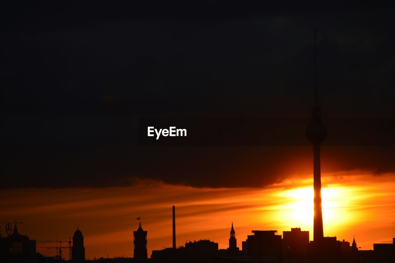 Silhouette of communication tower at sunset