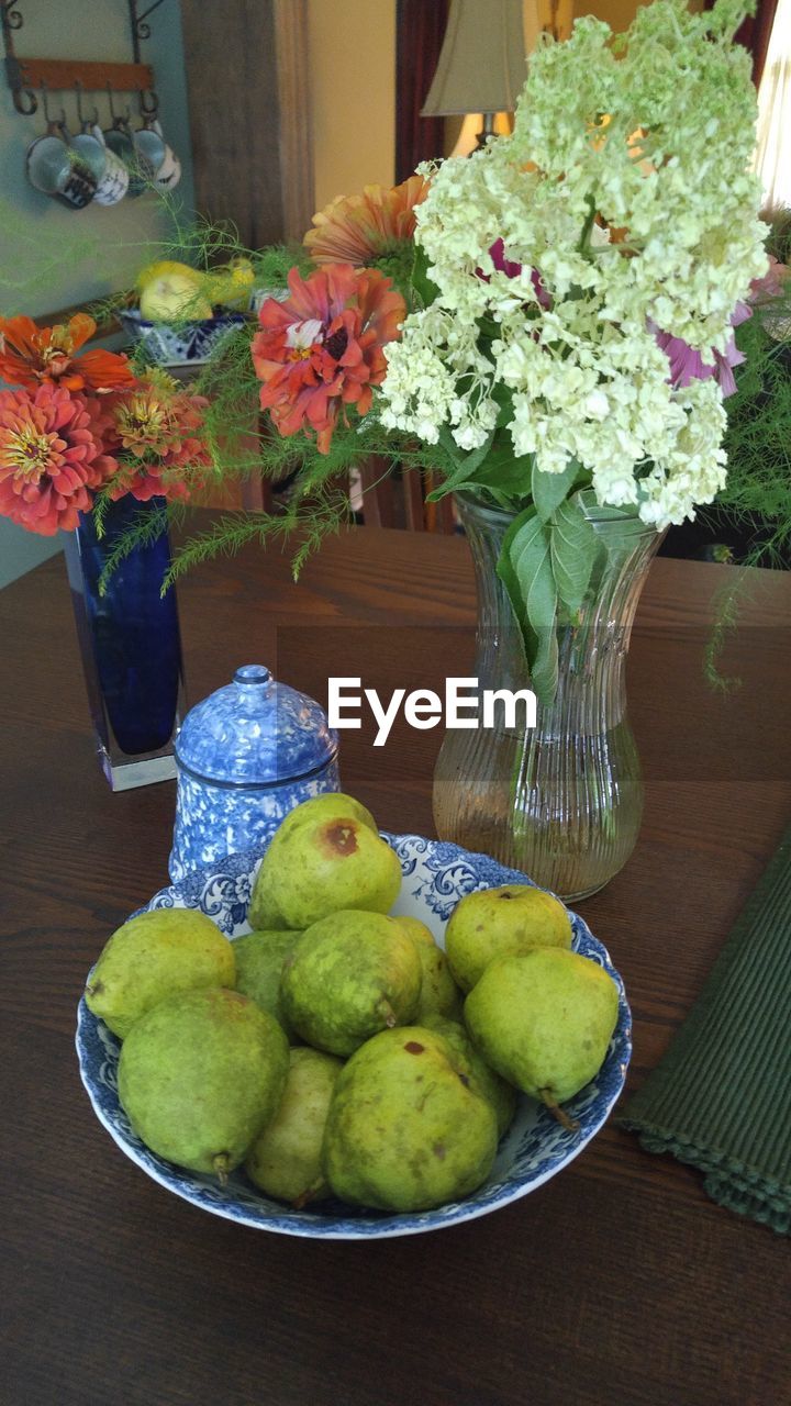 CLOSE-UP OF VASE ON TABLE