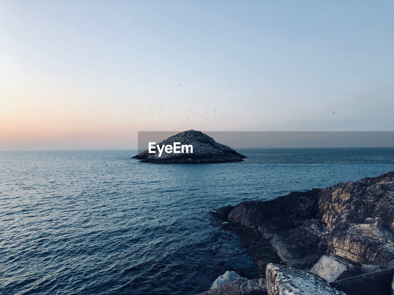 Scenic view of sea against clear sky during sunset