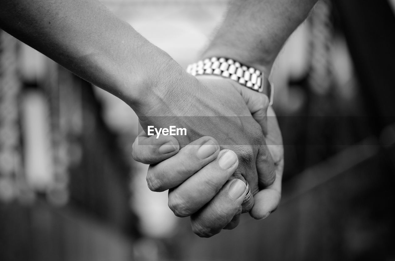 Close-up of couple with holding hands