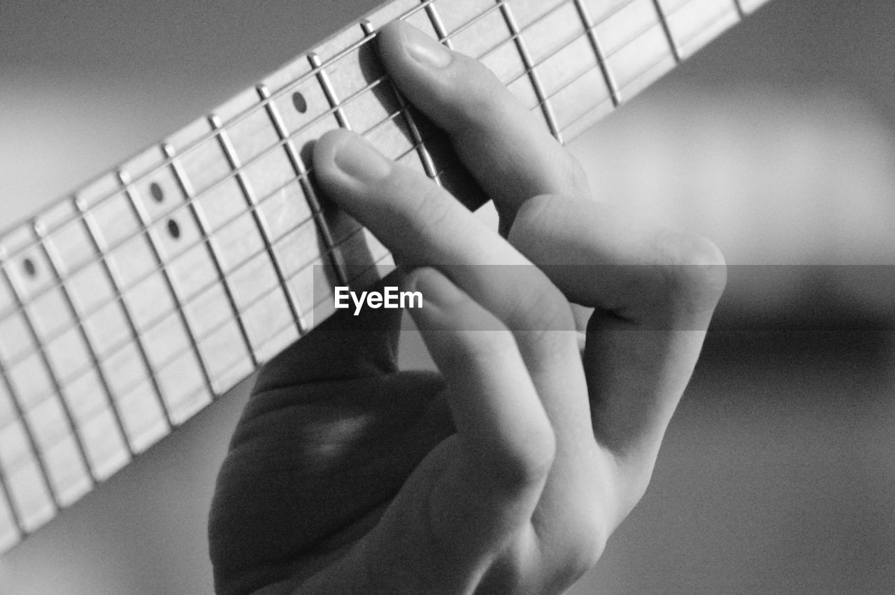 Close-up of hand playing guitar