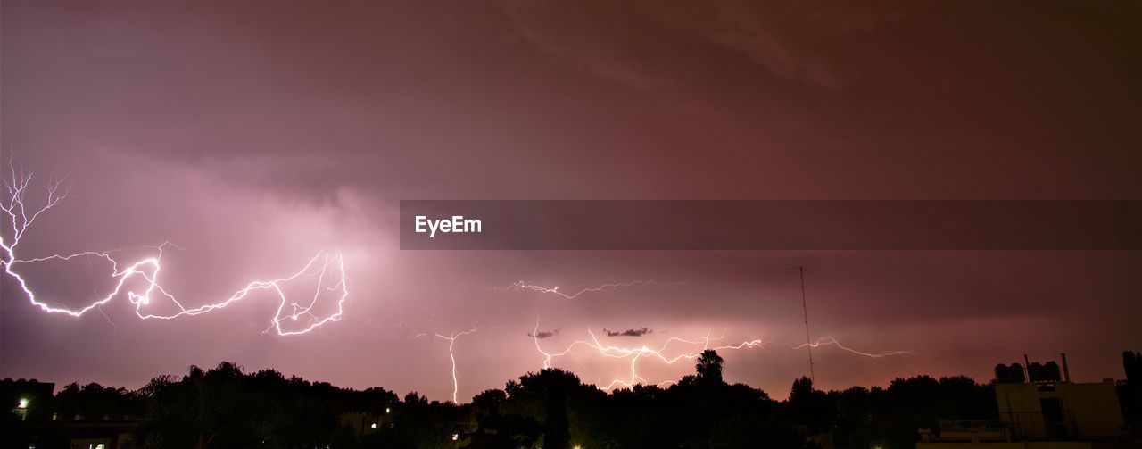 Panoramic view of lightning in sky at night