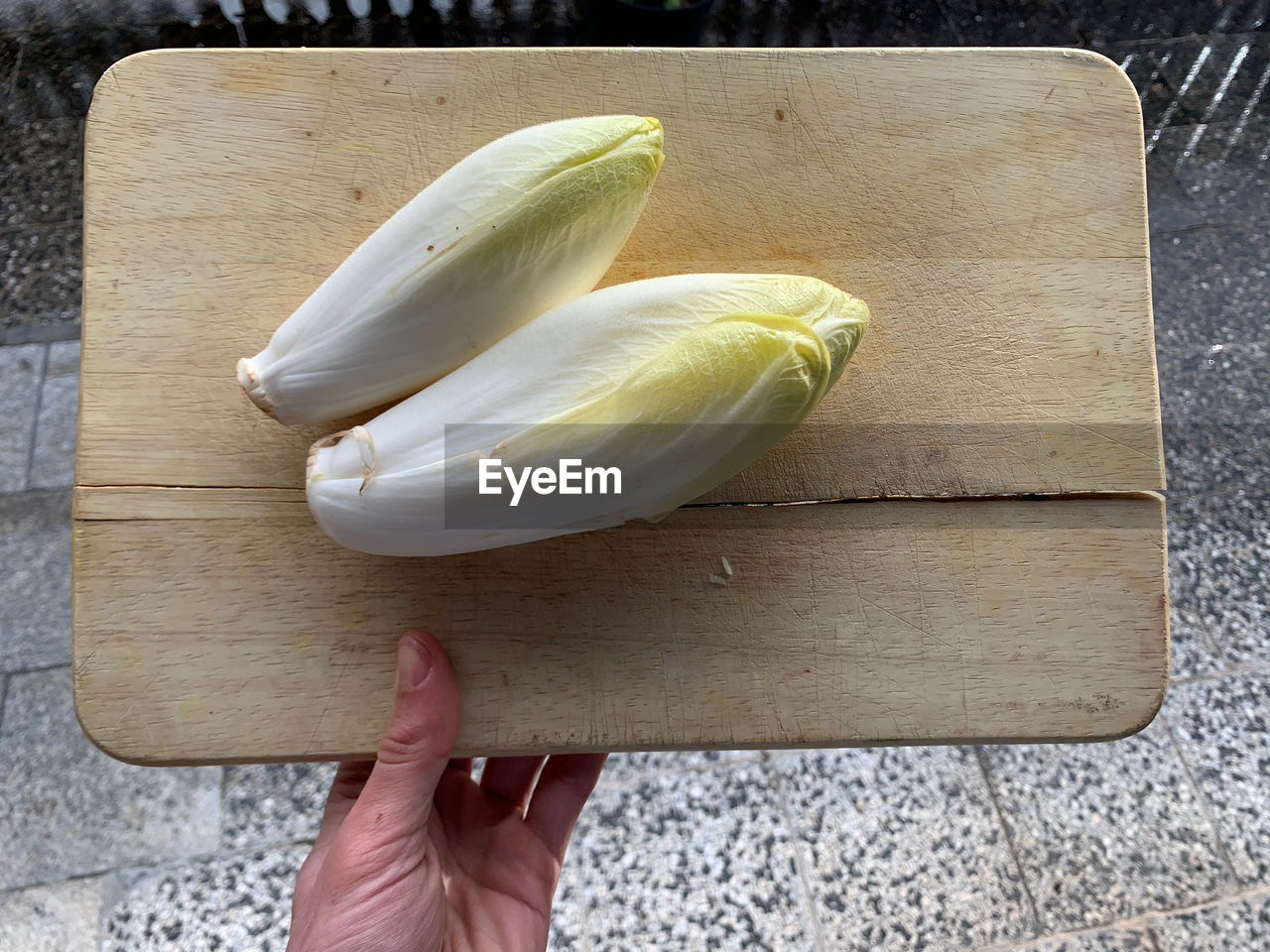 High angle view of fresh chicory vegetable on cutting board