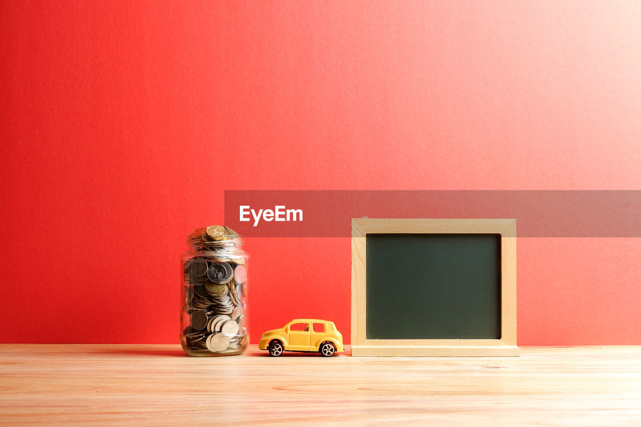 Objects on table against red wall