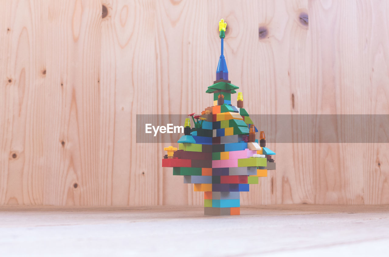 FULL FRAME SHOT OF COLORFUL OBJECTS ON WOODEN TABLE