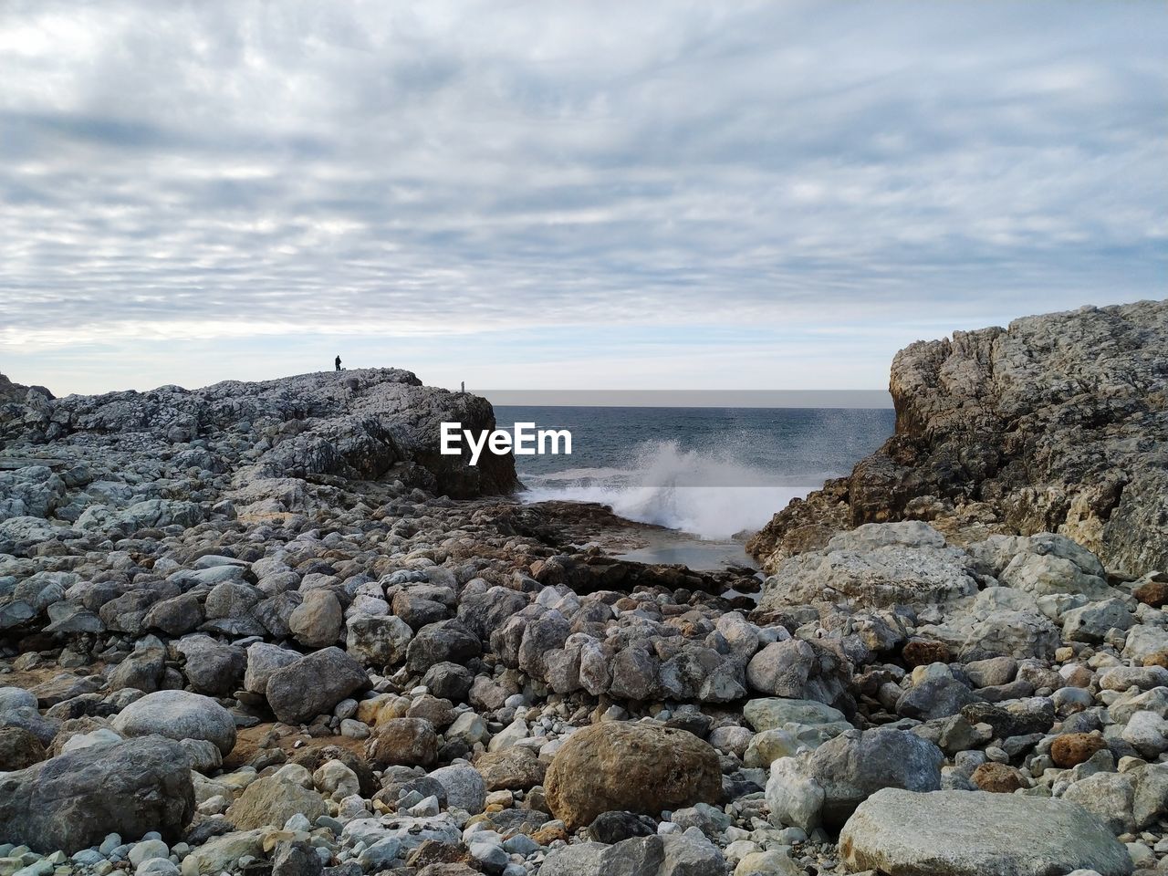 Rocks on beach against sky