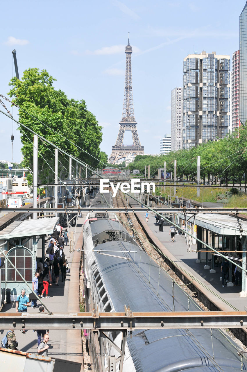 Train at station with eiffel tower against sky
