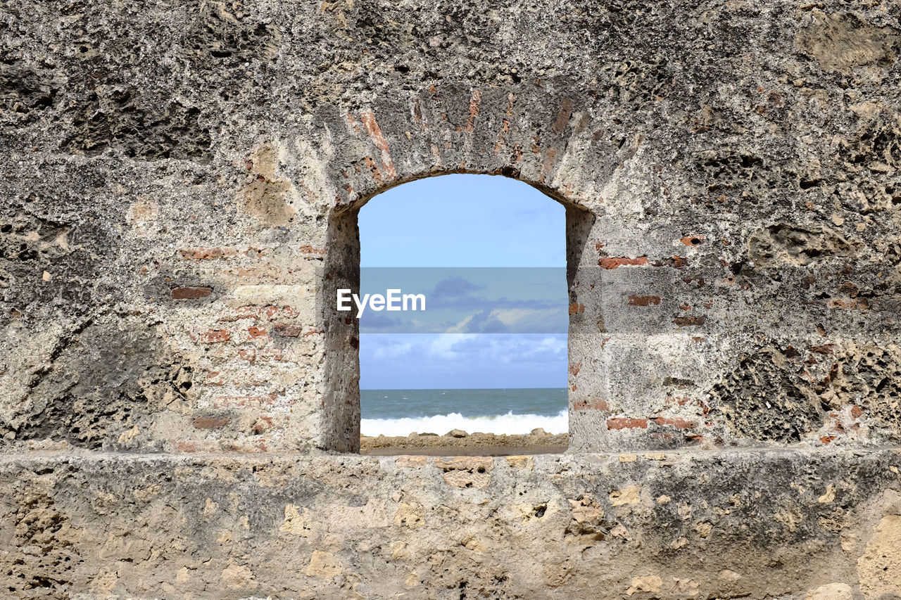 SEA SEEN THROUGH ARCH WINDOW