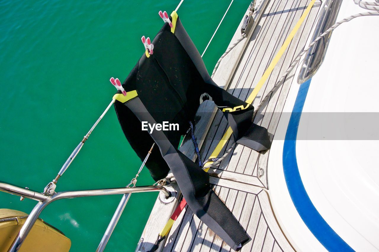 High angle view of wetsuit on ship in sea