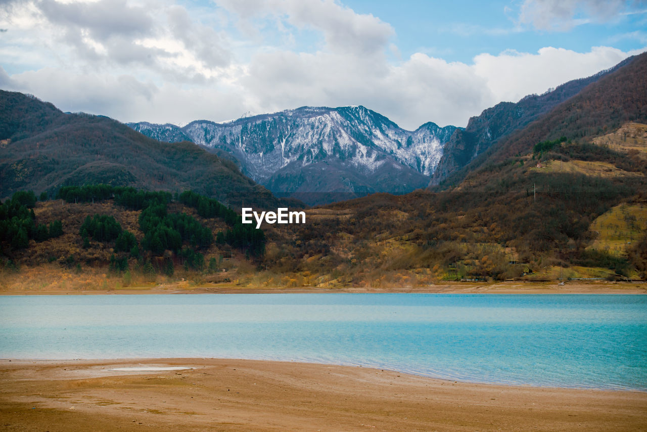 Scenic view of lake and mountains against sky