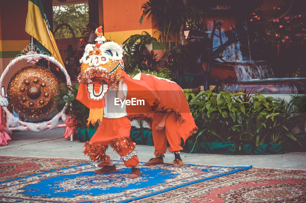 Man wearing dragon costume during festival