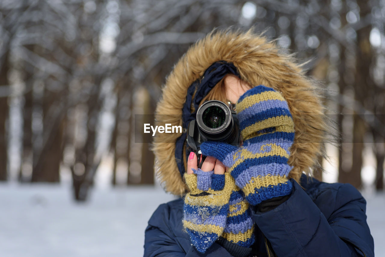 Close-up of woman photographing through camera