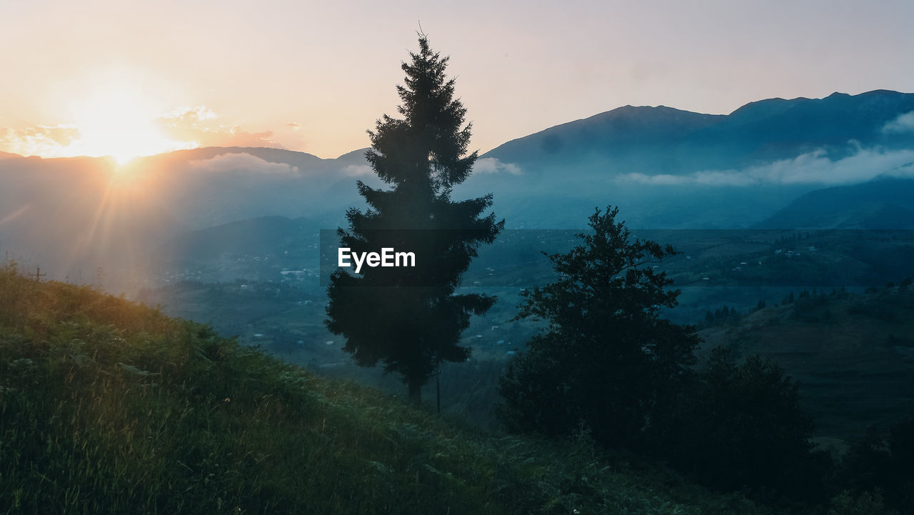 Scenic view of mountains against sky during sunset