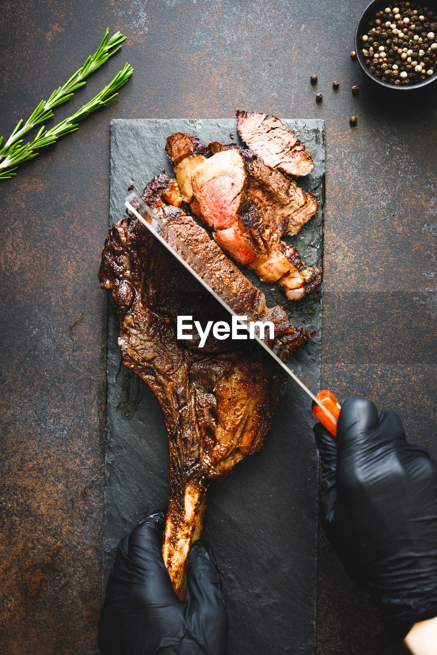 HIGH ANGLE VIEW OF PERSON PREPARING FOOD